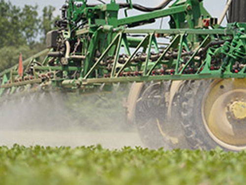 A sprayer applying crop protection on a field.
